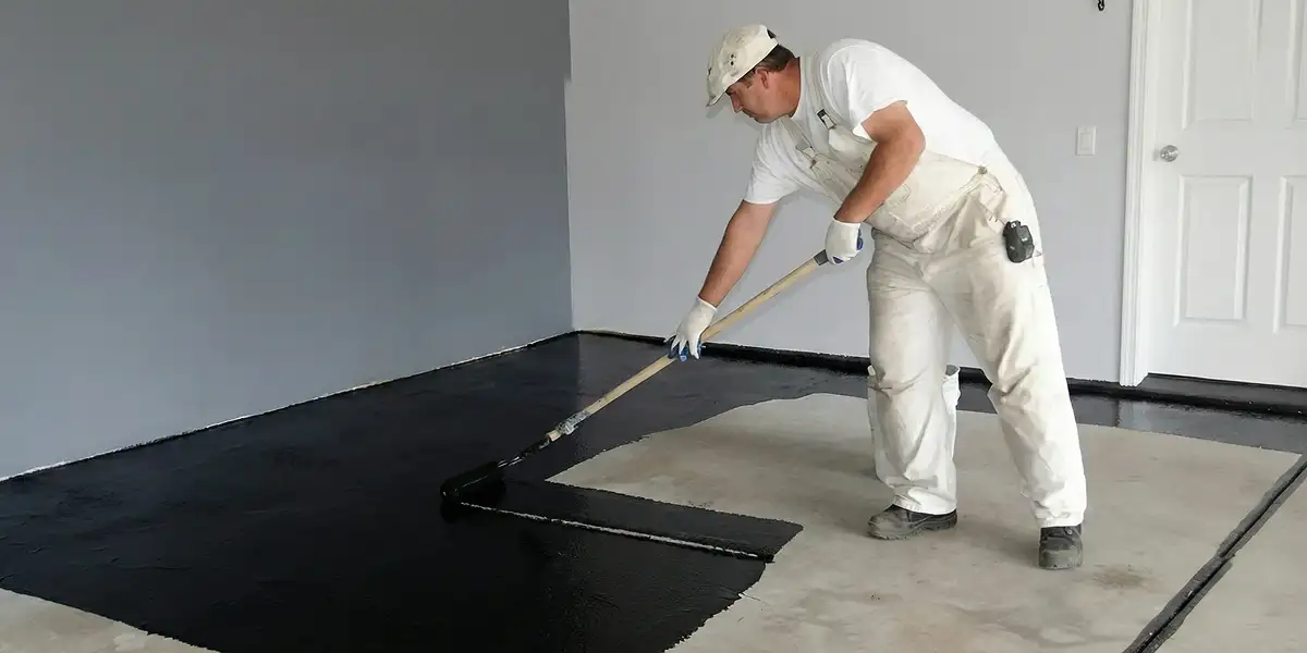 basement waterproofing professional applying waterproof coating to protect a basement floor in Orange, CA