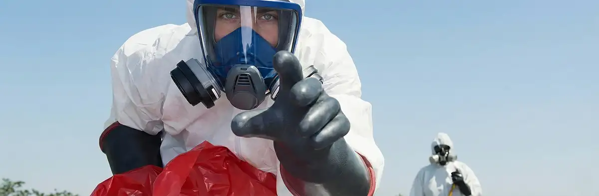 sewage clean up technician wearing protective gear handling biohazard materials in Orange, CA