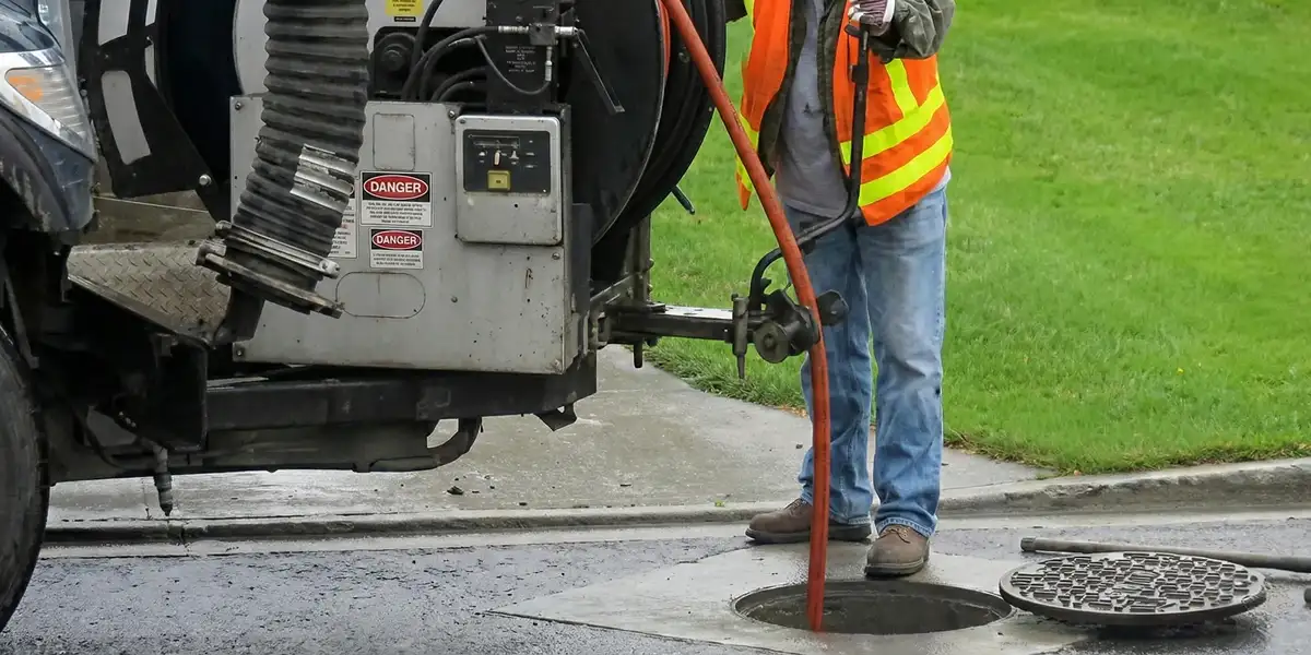 sewage clean up professionals using industrial equipment to remove contaminated wastewater in Orange, CA