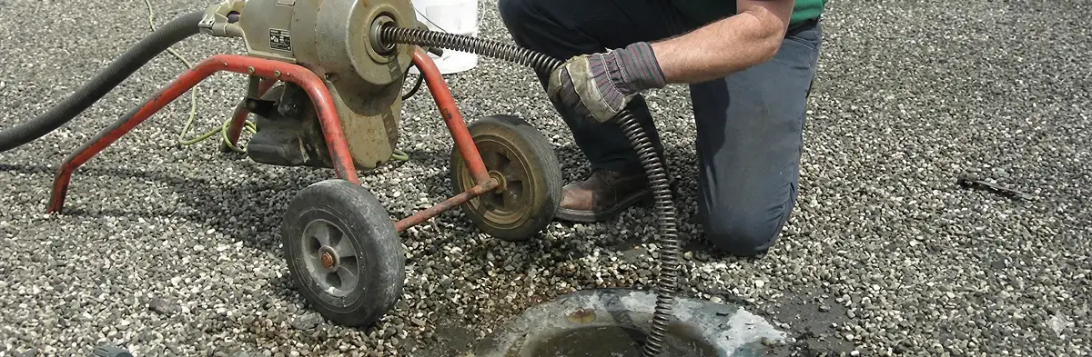 sewer rodding technician actively removing blockages from a sewer line in Orange, CA